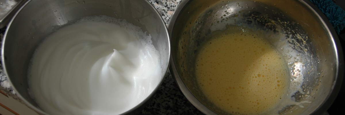 Whipped egg whites and egg yolks ready to be folded together for an omelet.