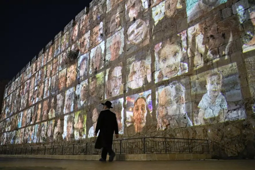 Images of the hostages taken by Hamas on October 7, 2023, projected onto the walls of The Old City of Jerusalem (Source: AP Photo /Leo Correa)